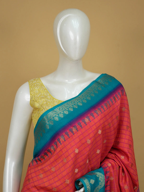 Coral red Dola silk saree with pink checks, gold zari buttas and a contrast teal blue zari border