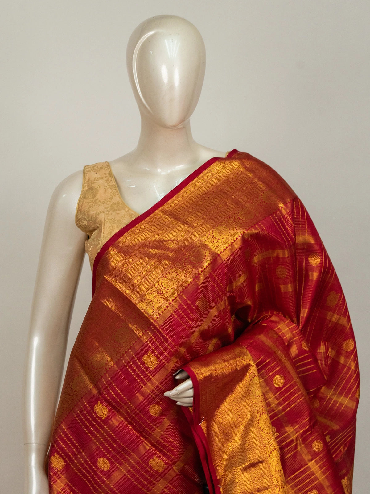Red and gold pure Kanchipuram silk saree with checked body, gold zari buttas and ornate temple zari border