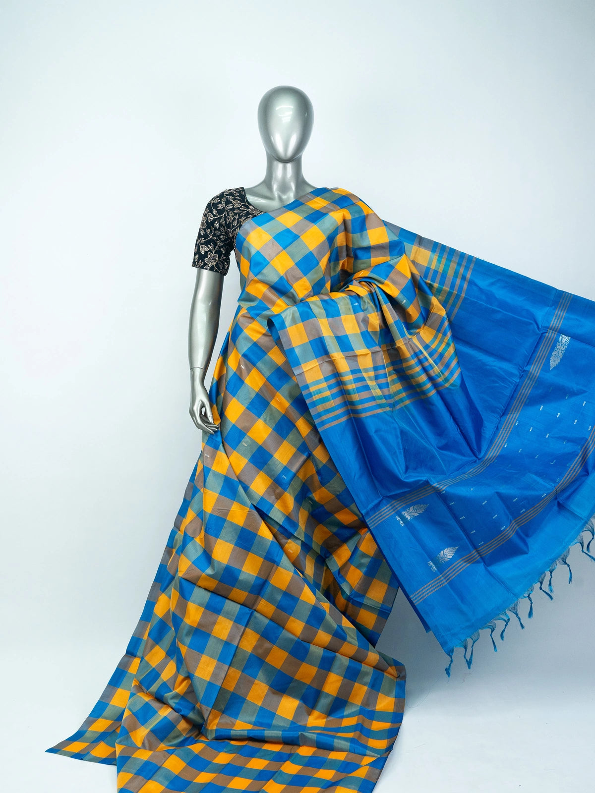 Blue and yellow checked banana silk saree with solid blue pallu and silver zari motifs
