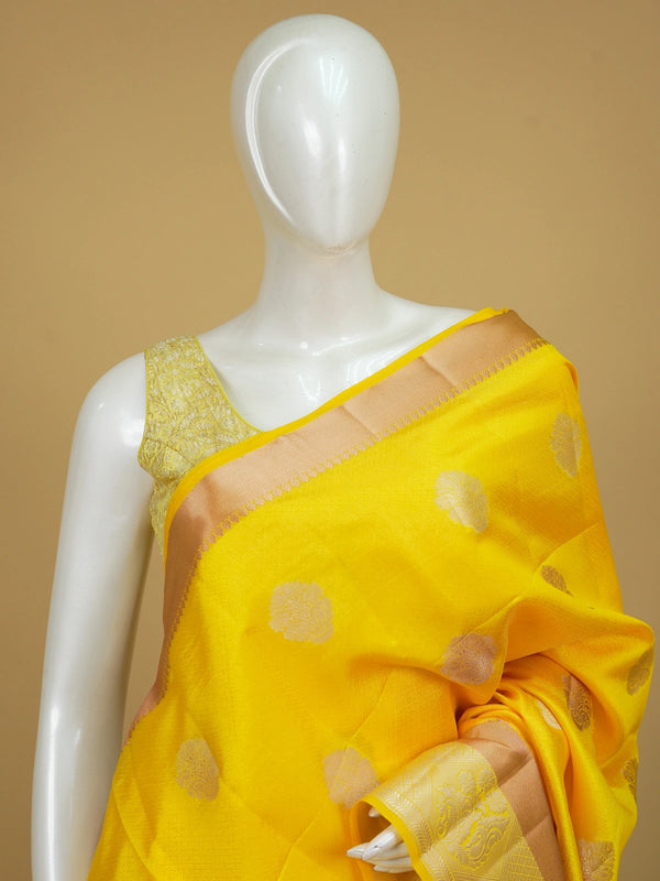 Bright yellow semi tussar saree with silver and gold zari butta motifs and contrast zari border