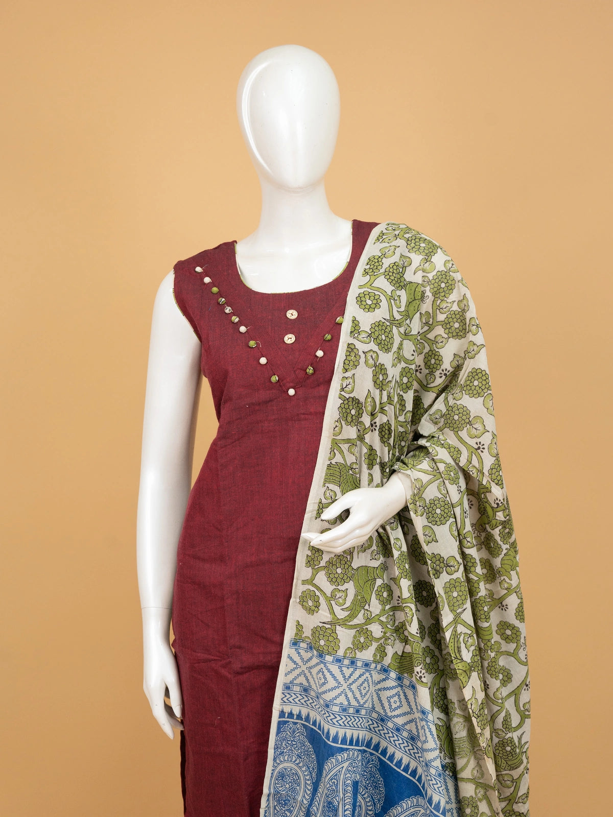 Maroon cotton straight cut kurti set with pom-pom neckline, green kalamkari printed pants and contrast kalamkari dupatta