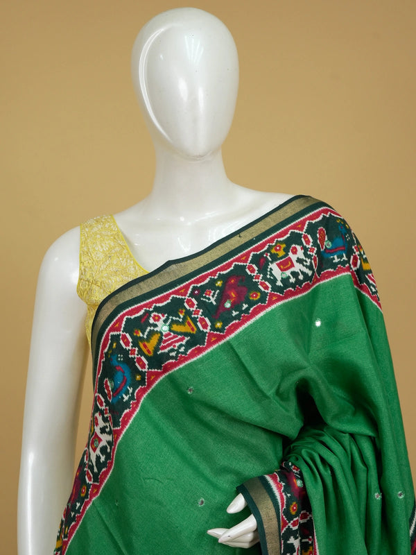 Green linen cotton saree with red patola ikat border, mirror work and multicolour pallu motifs
