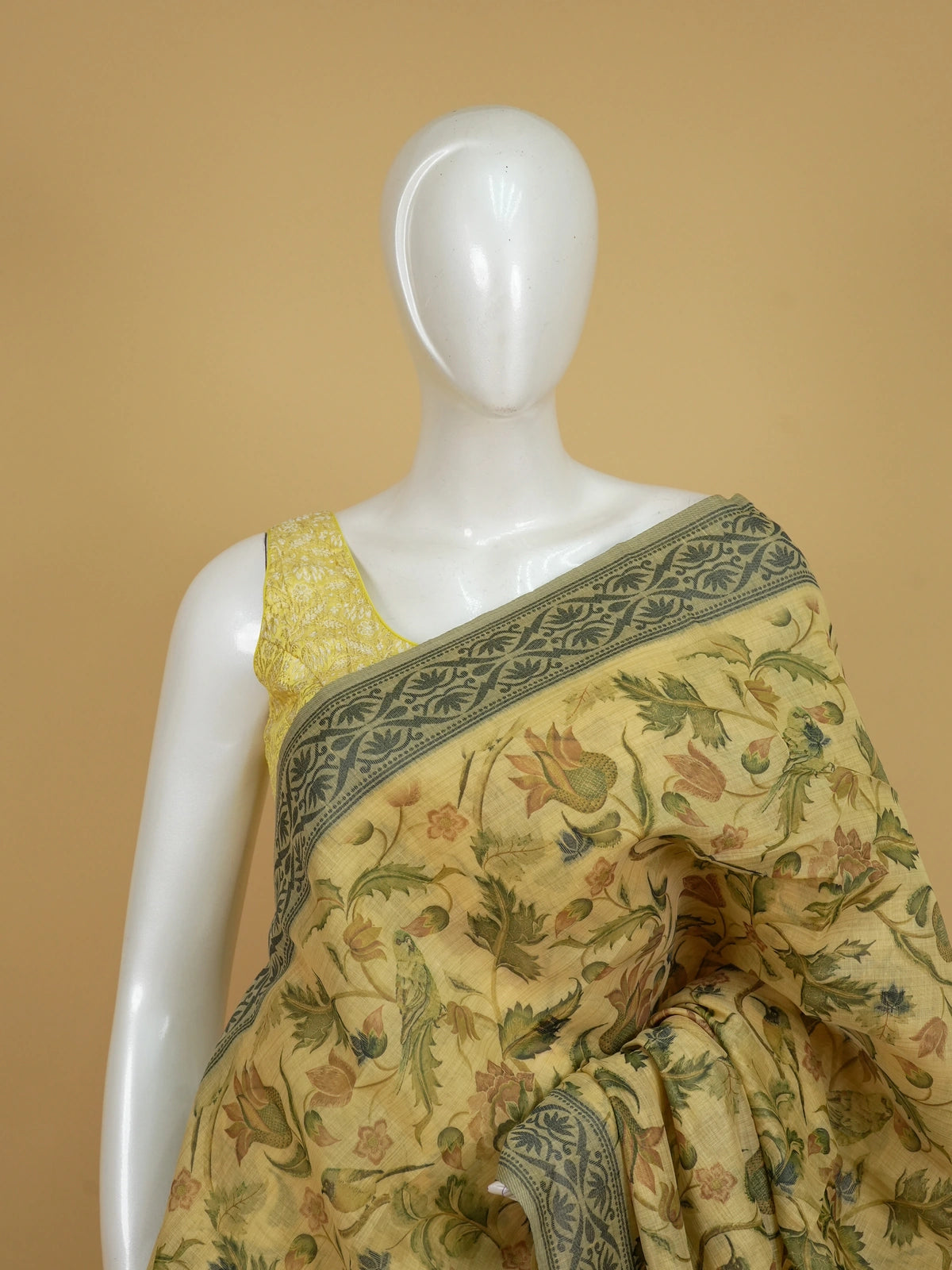 Beige linen cotton saree with floral print, grey-green border and Kalamkari-style Radha-Krishna pallu