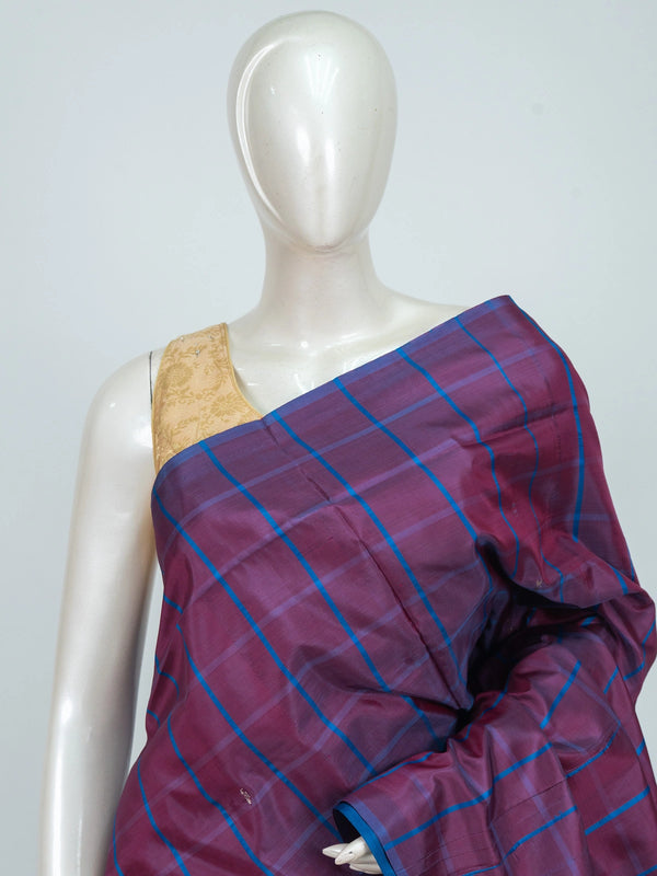 Purple and blue checked banana silk saree with contrast blue border and silver zari paisley pallu