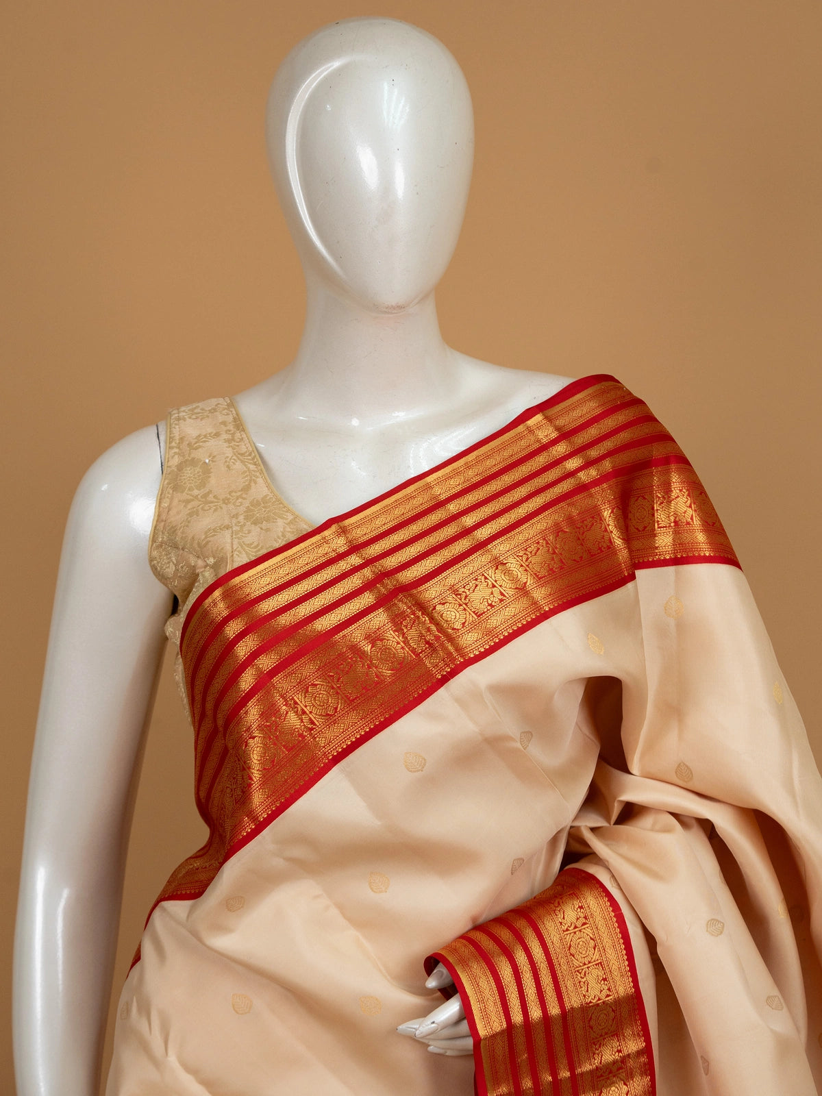 Cream pure Kanchipuram silk saree with contrast red gold zari border and pallu