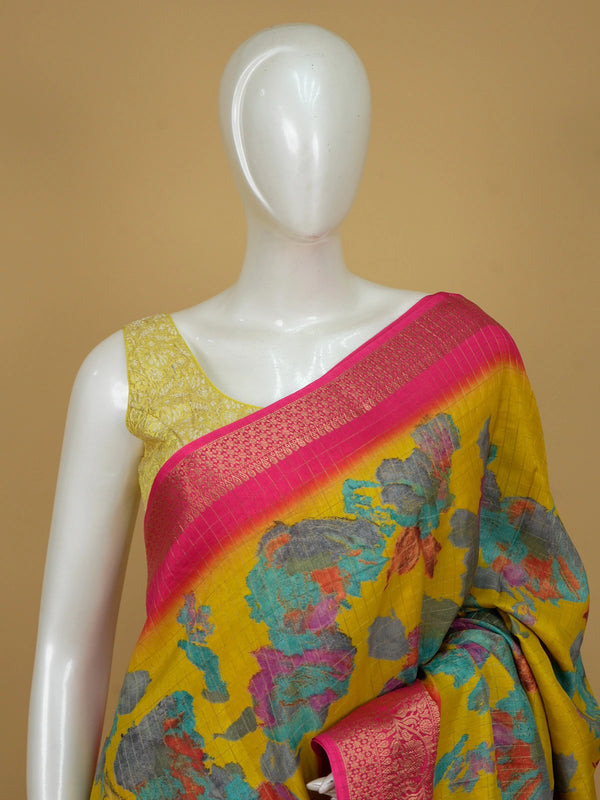 Yellow Dola silk saree with multicoloured floral print and contrast pink zari border