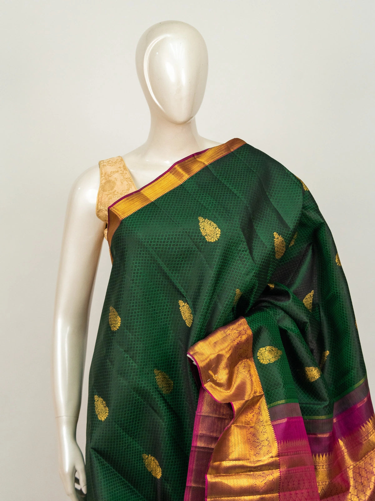 Bottle green pure Kanchipuram silk saree with magenta and gold zari contrast border and zari brocade pallu