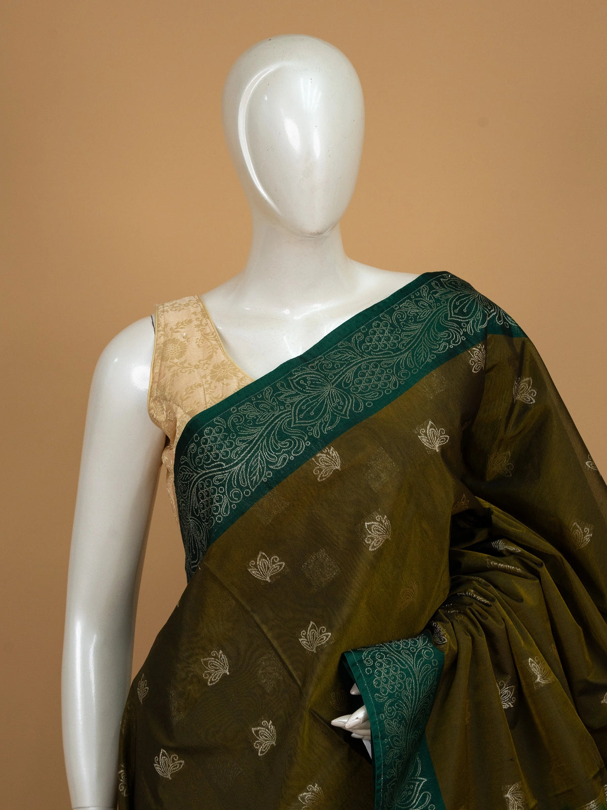 Mehendi green silk cotton saree with contrast bottle green zari border and silver lotus buttas