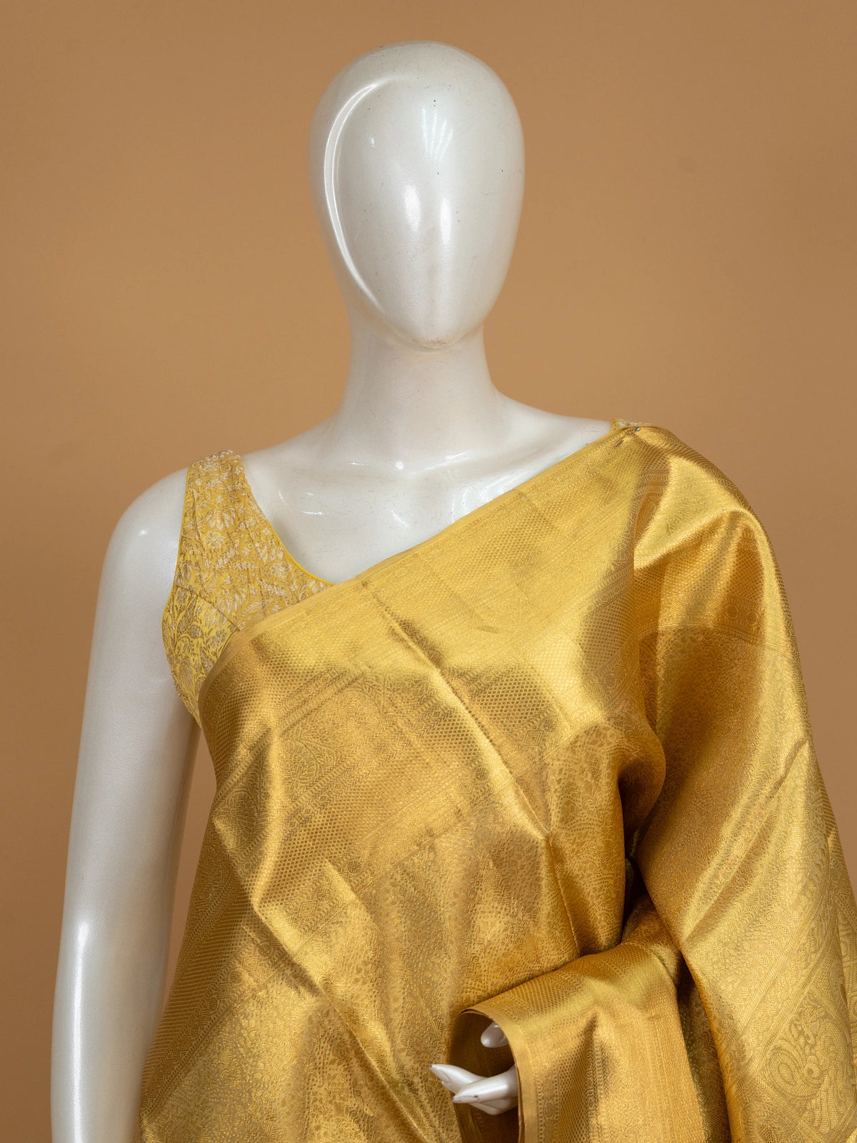 Gold pure Kanchipuram silk saree with all-over zari weave and ornate paisley-peacock pallu