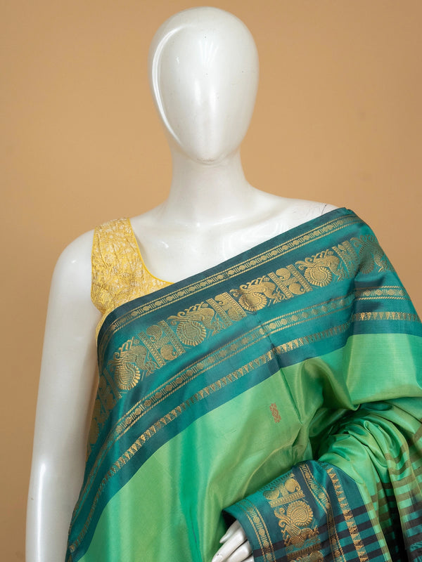 Green and black Banana Silk saree with gold zari peacock border and contrast pallu