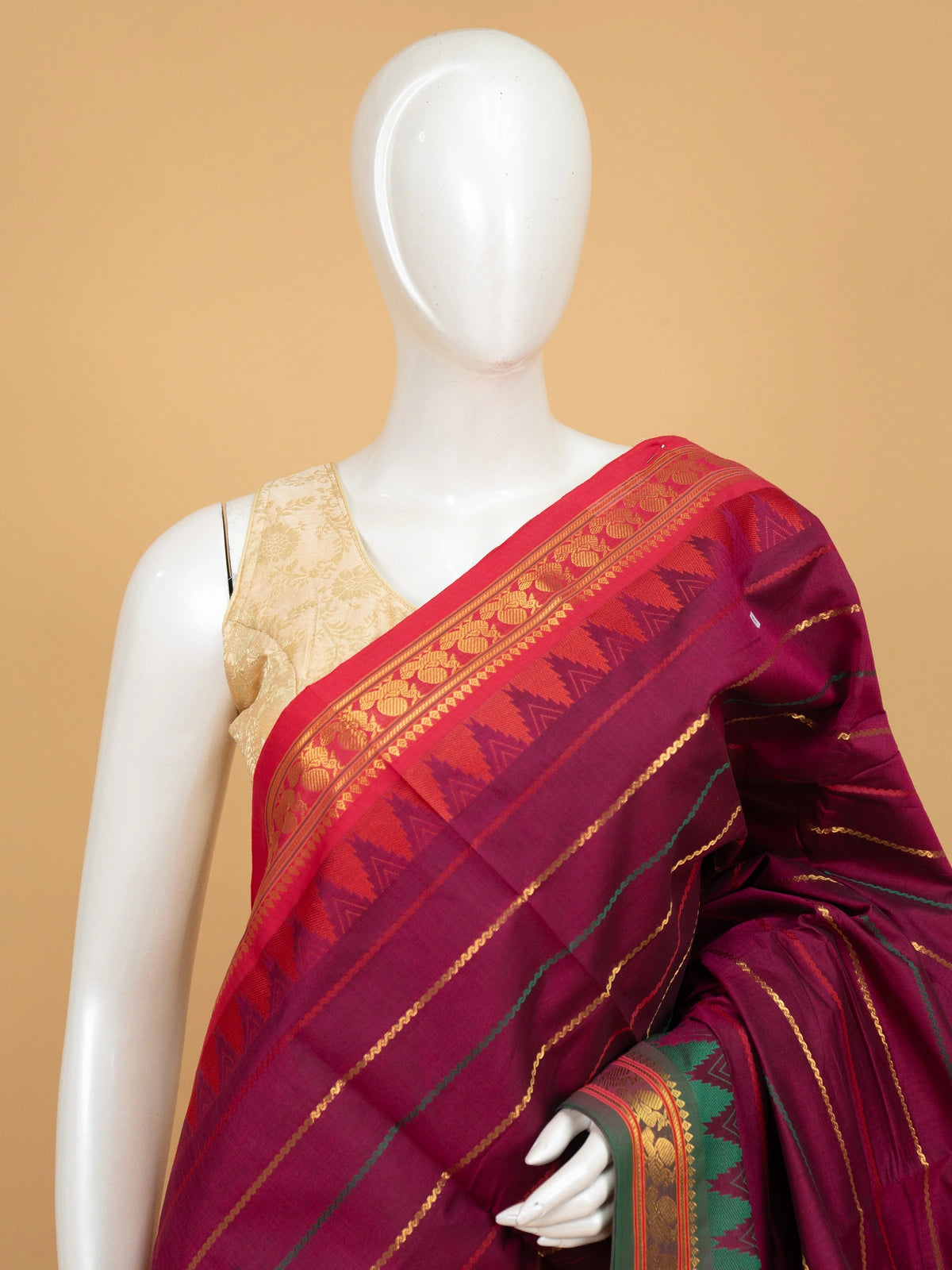 Magenta wine Chettinad cotton saree with red contrast border, gold zari peacock motifs and green temple design