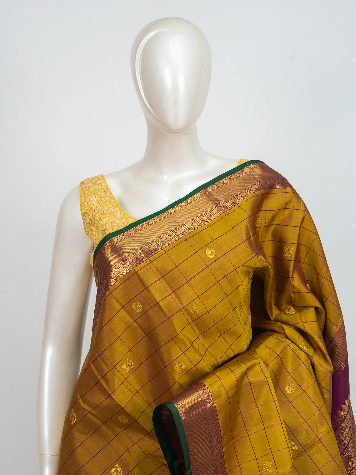Mustard yellow pure Kanchipuram silk saree with checked body, gold zari buttas and contrast magenta zari border and pallu