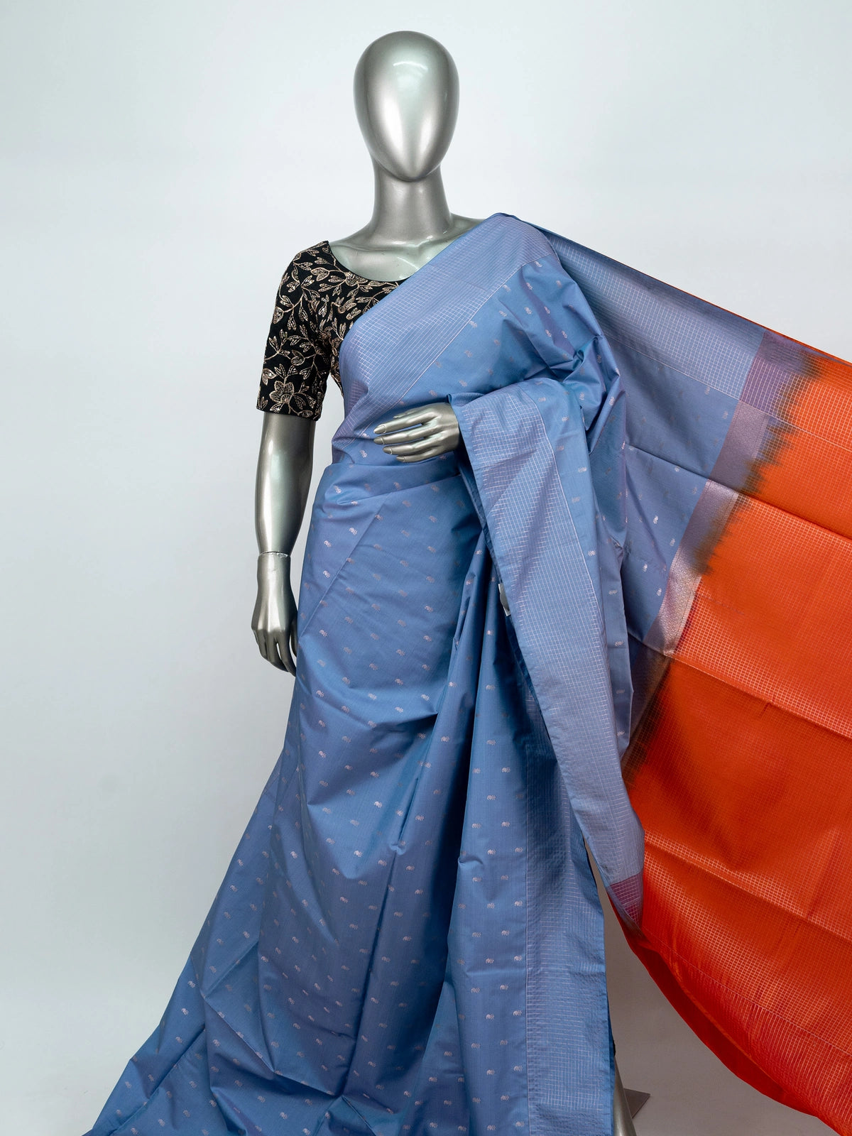Dusty blue-grey Vaira Oosi Design semi silk saree with silver zari buttis and contrast orange zari pallu and border