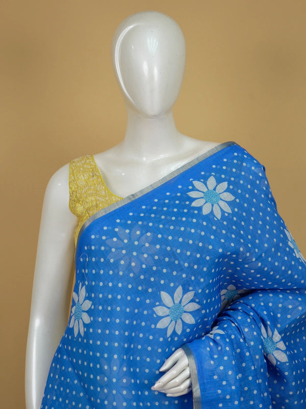 Bright blue linen cotton saree with white polka dots, daisy floral motifs and silver zari border