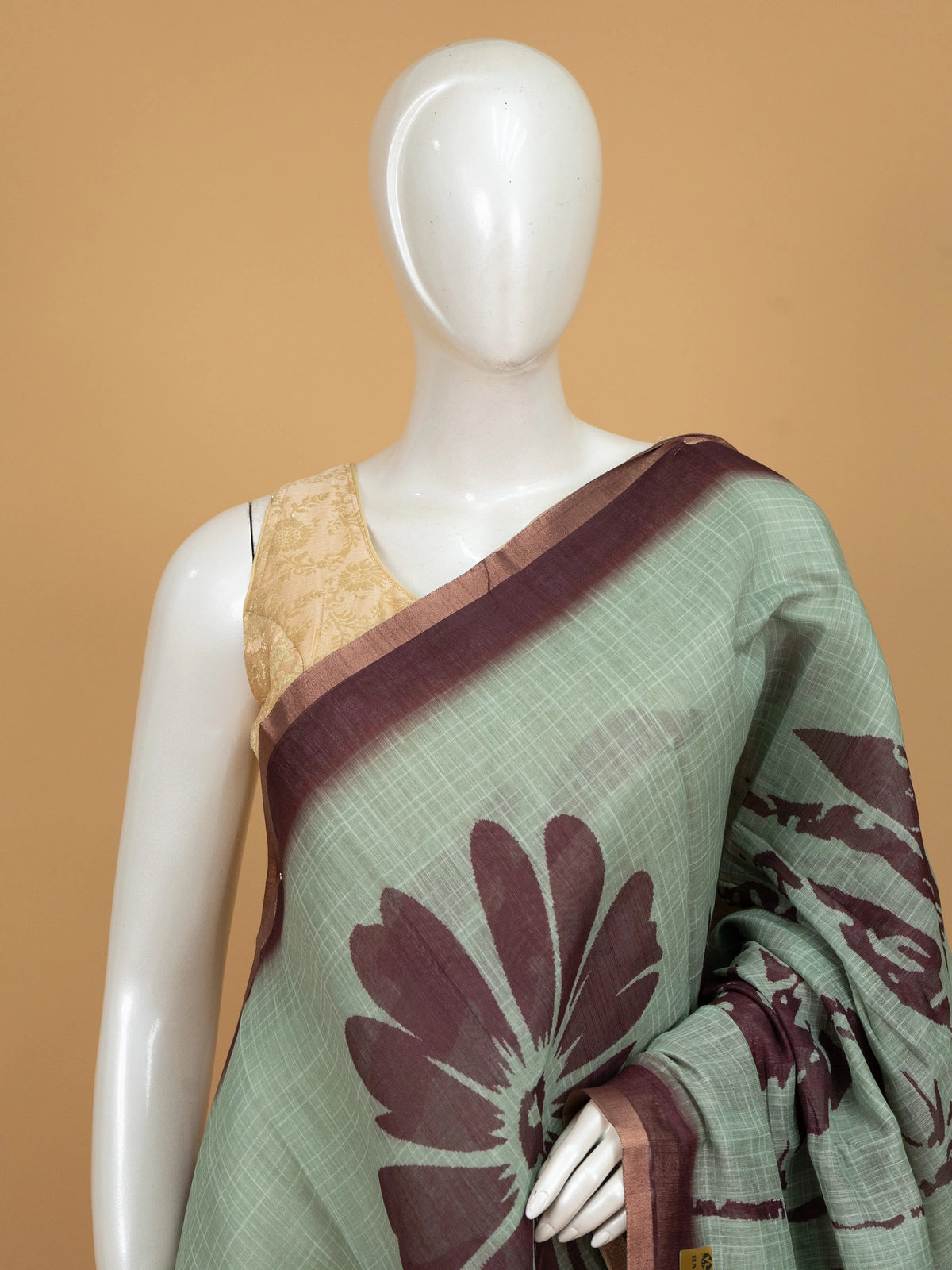 Sage green linen cotton saree with maroon floral prints and contrast maroon border
