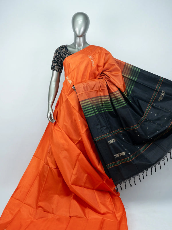 Orange Banana Silk saree with contrast black striped pallu, gold zari buttas and embroidered black blouse
