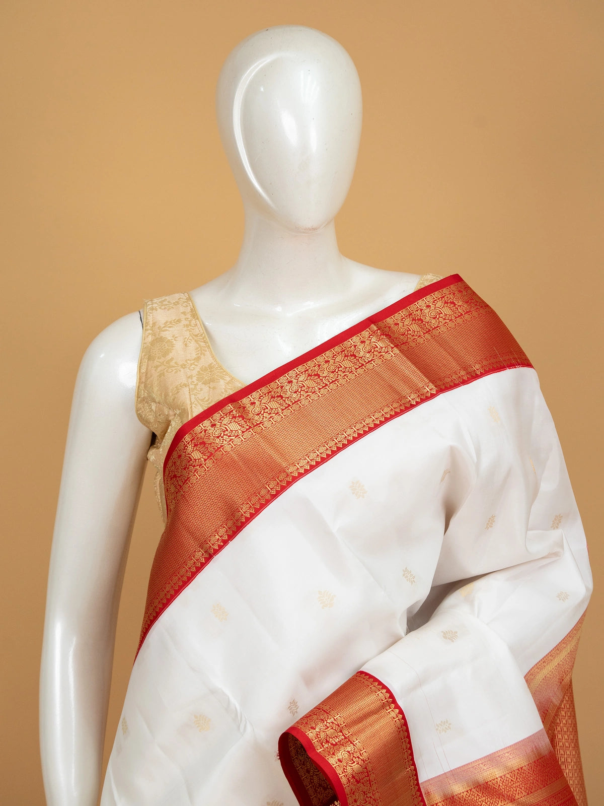 White pure Kanchipuram silk saree with contrast red border and gold zari buttas and pallu