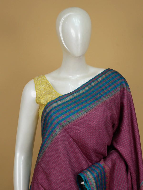 Magenta pink Dola silk saree with teal-blue contrast checked border and floral motif pallu