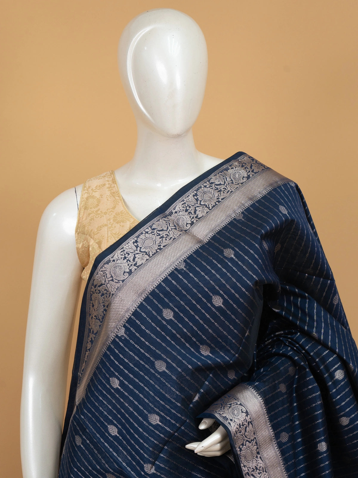 Navy blue silk cotton saree with silver zari stripes, buttis and ornate zari border