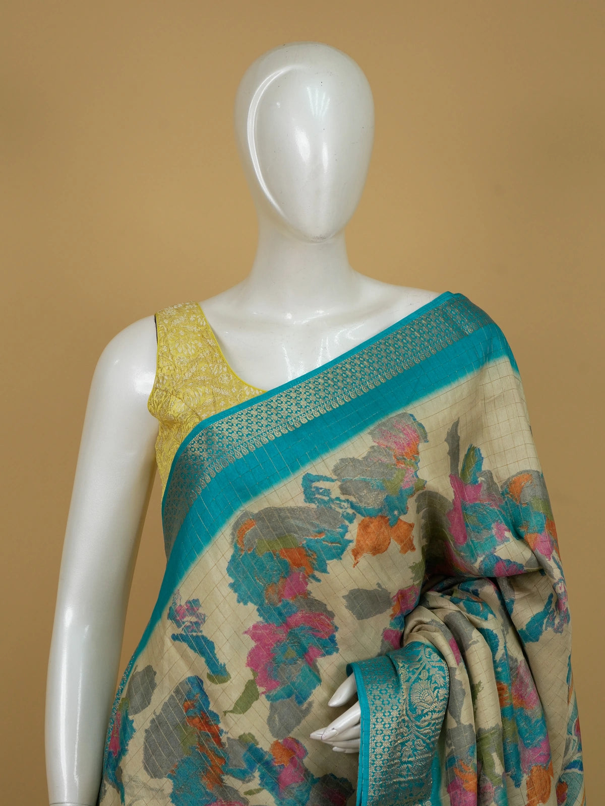 Cream Dola silk saree with multicolour floral print and turquoise zari border