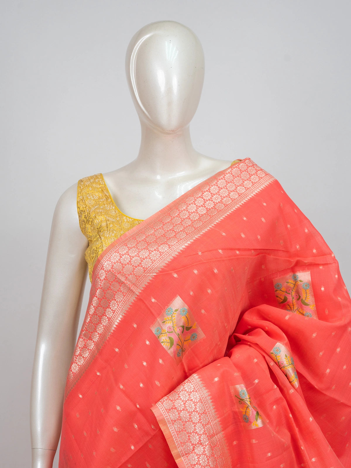 Coral linen cotton saree with silver zari border, floral butti motifs and trellis-work pallu