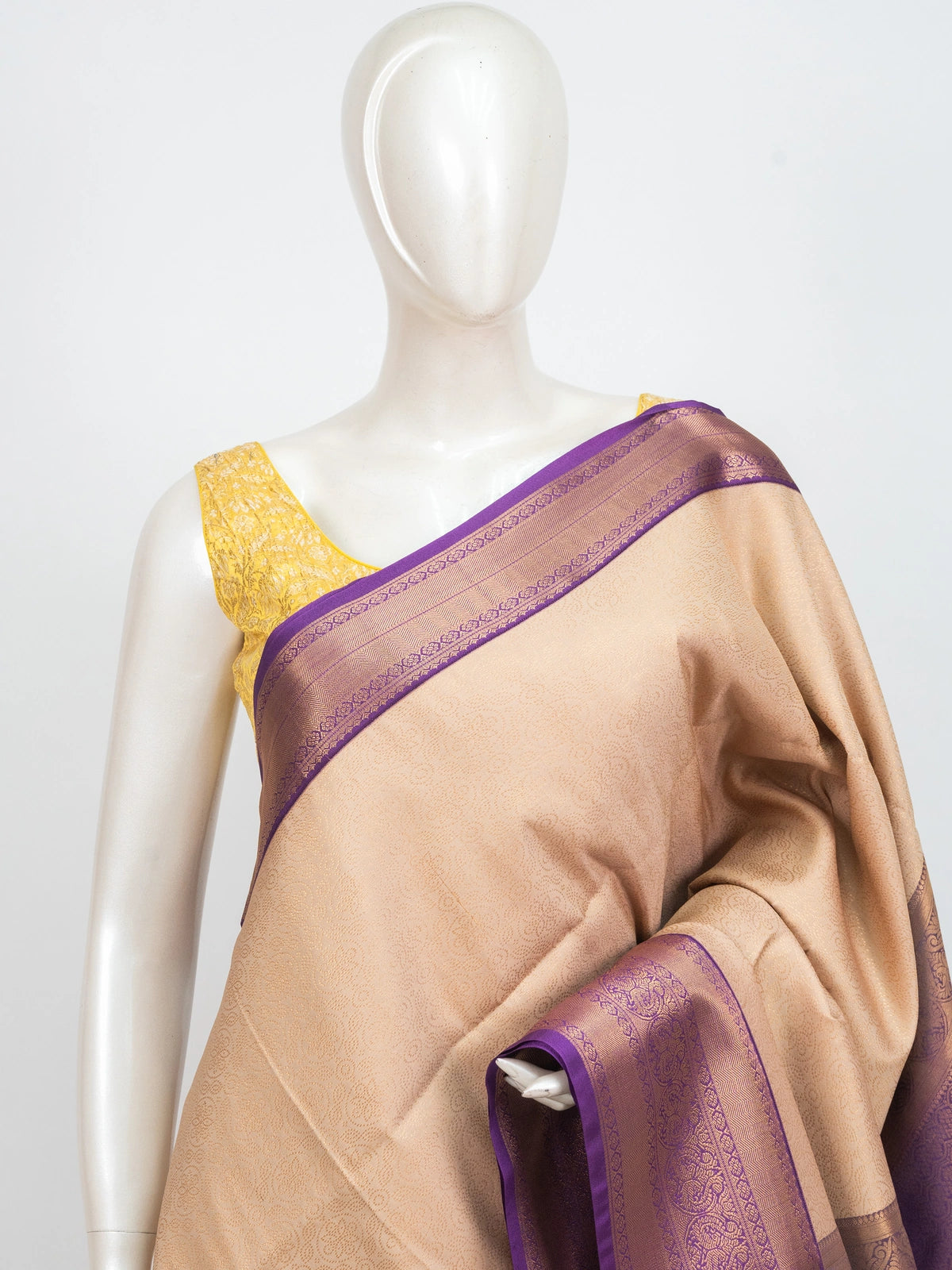 Beige Kanchipuram Fancy Silk saree with contrast purple and gold zari border and pallu