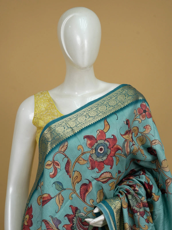 Teal blue semi tussar saree with Kalamkari floral and peacock print and gold zari border