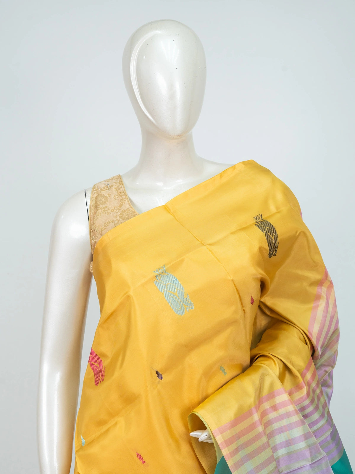 Mustard yellow banana silk saree with turquoise contrast pallu and colourful woven butta motifs