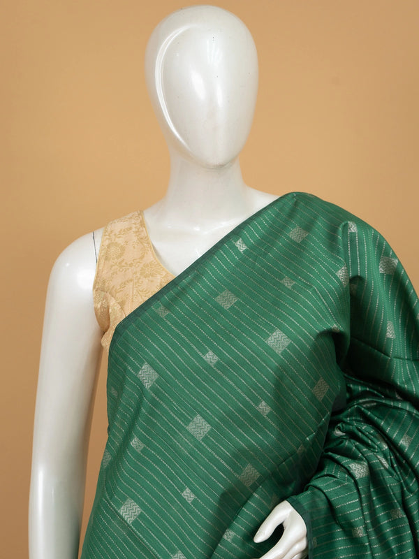 Bottle green silk cotton saree with silver zari stripes and contrast magenta border and pallu
