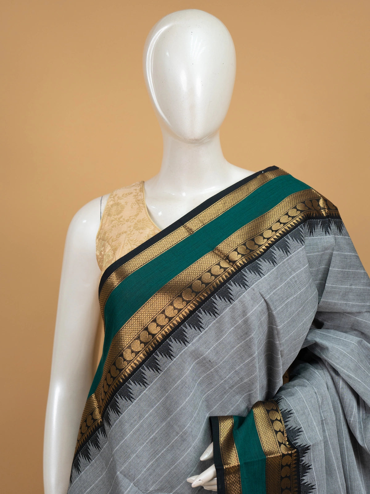 Grey Chettinad cotton saree with fine white stripes and contrast green gold zari temple border