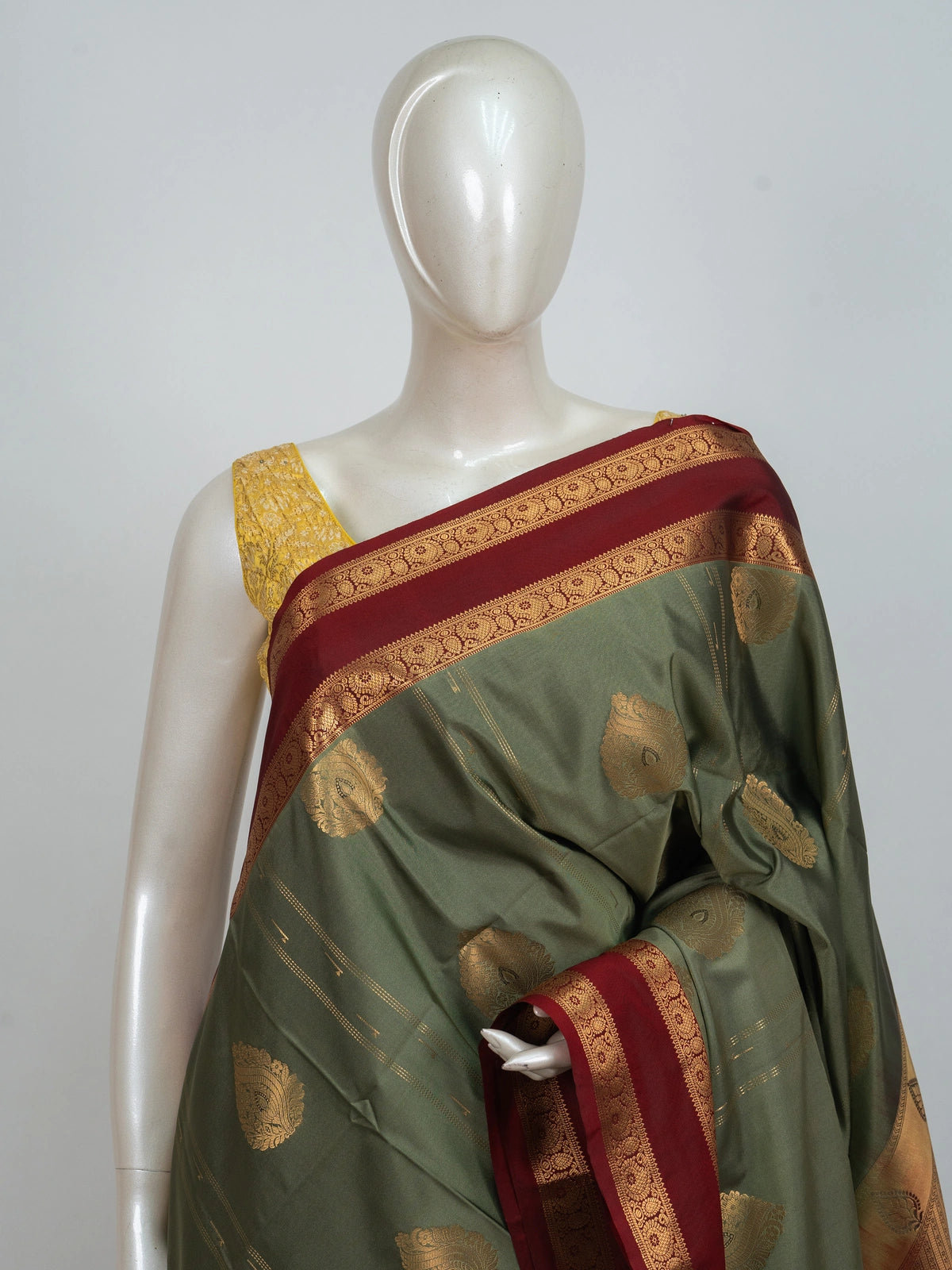 Olive green Kanchipuram fancy silk saree with contrast maroon and gold zari border and paisley pallu