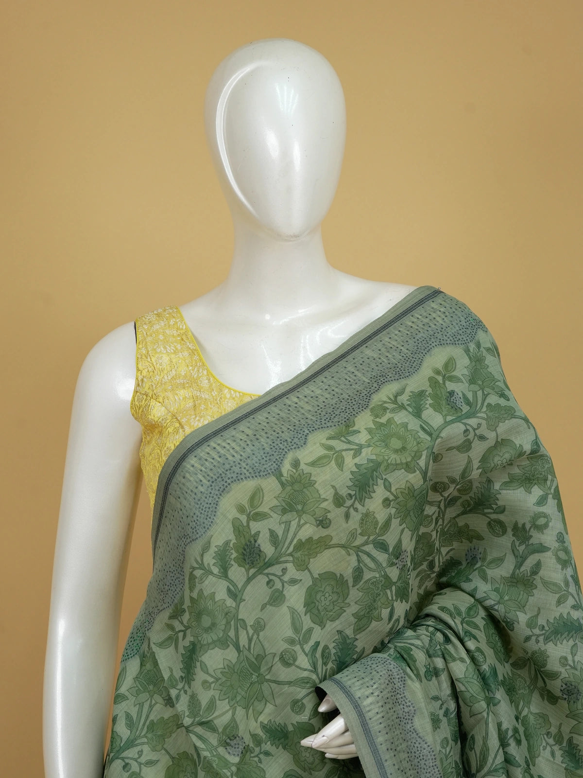 Sage green floral printed linen cotton saree with grey dotted border and tree-motif pallu