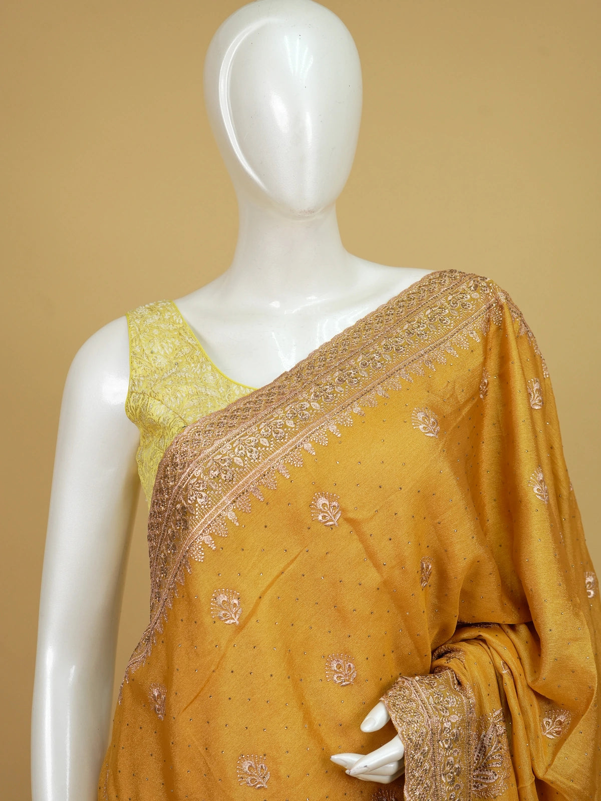 Mustard yellow designer saree with rose-gold embroidered butas, paisley pallu and embellished border
