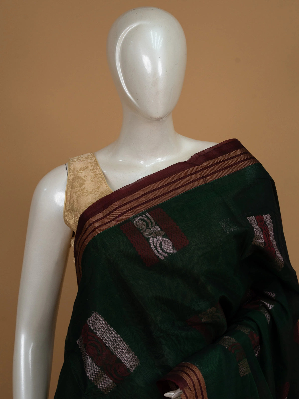 Dark green silk cotton saree with contrast maroon border, copper-gold stripes and silver woven buttas