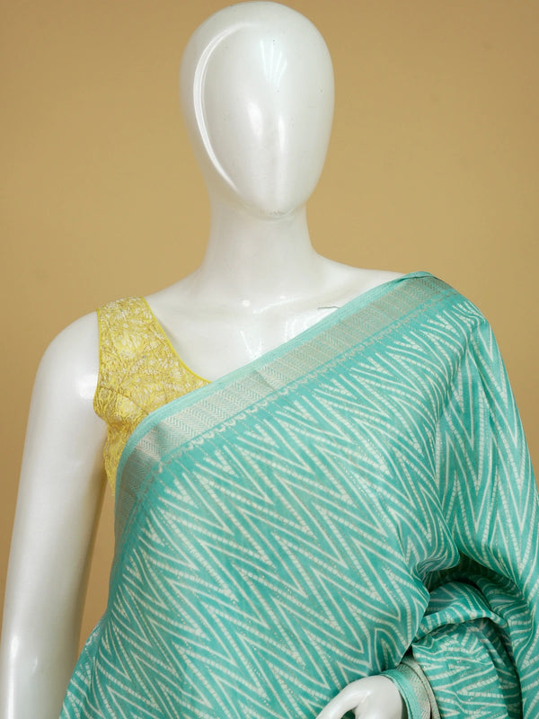Sea green designer saree with gold zari chevron print, tree-motif pallu and contrast yellow blouse
