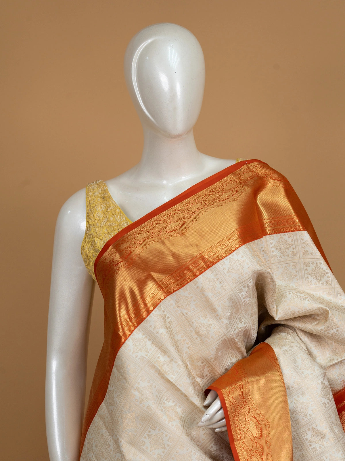 Cream Pure Kanchipuram silk saree with gold zari checkerboard body and contrast orange zari border