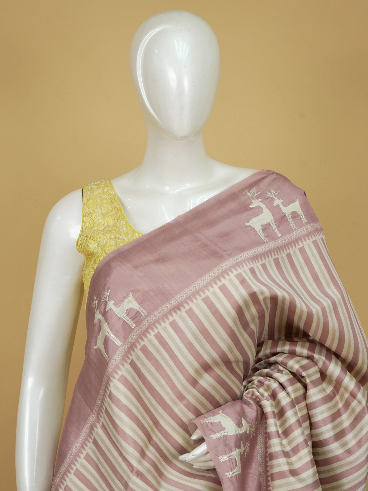 Dusty pink and cream designer silk saree with deer motifs and floral embroidered pallu