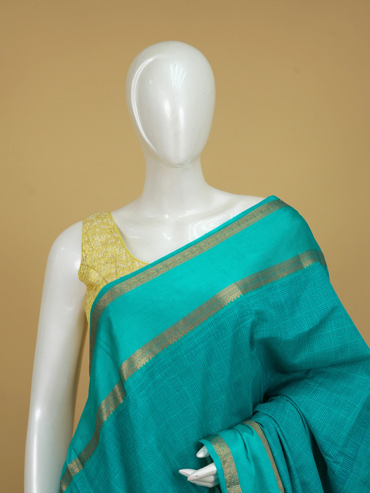 Teal green semi tussar saree with geometric body pattern and gold zari border