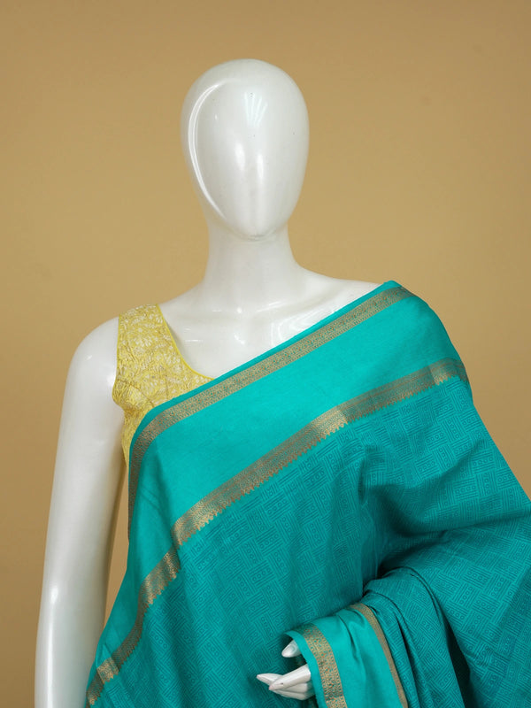 Teal green semi tussar saree with geometric body pattern and gold zari border