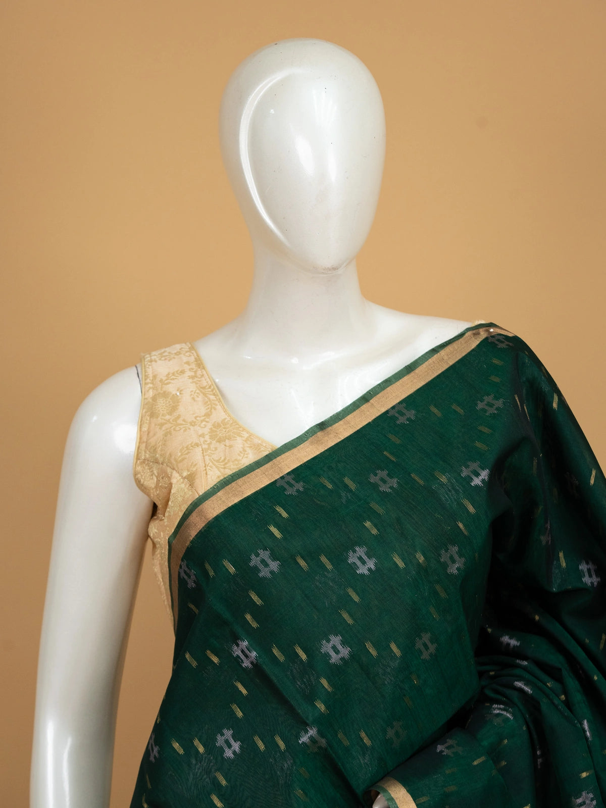 Dark green pure silk cotton saree with gold zari floral border and ikat-style buttas