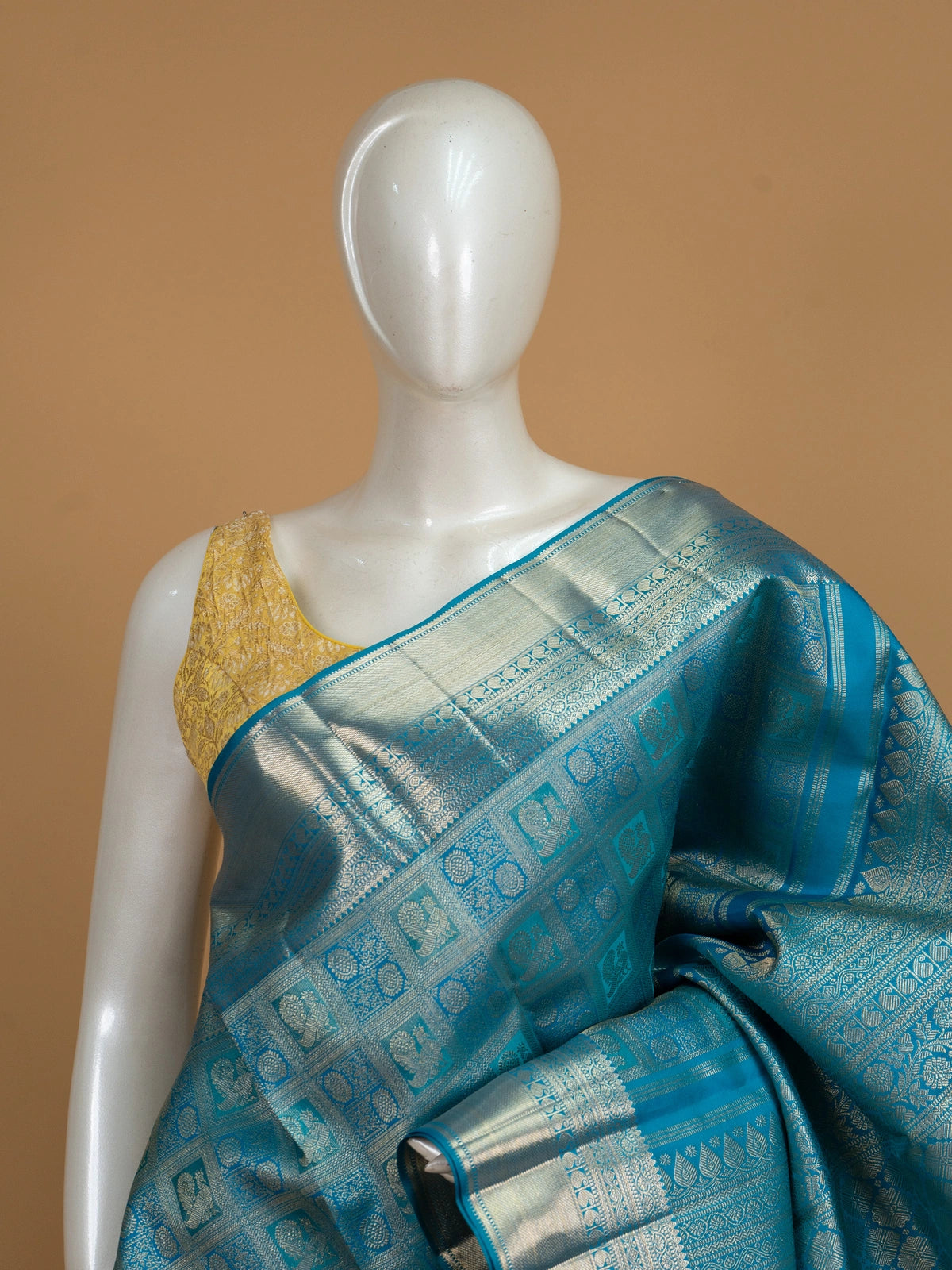 Peacock blue pure Kanchipuram silk saree with silver zari checkerboard motifs, broad zari border and jaali pallu