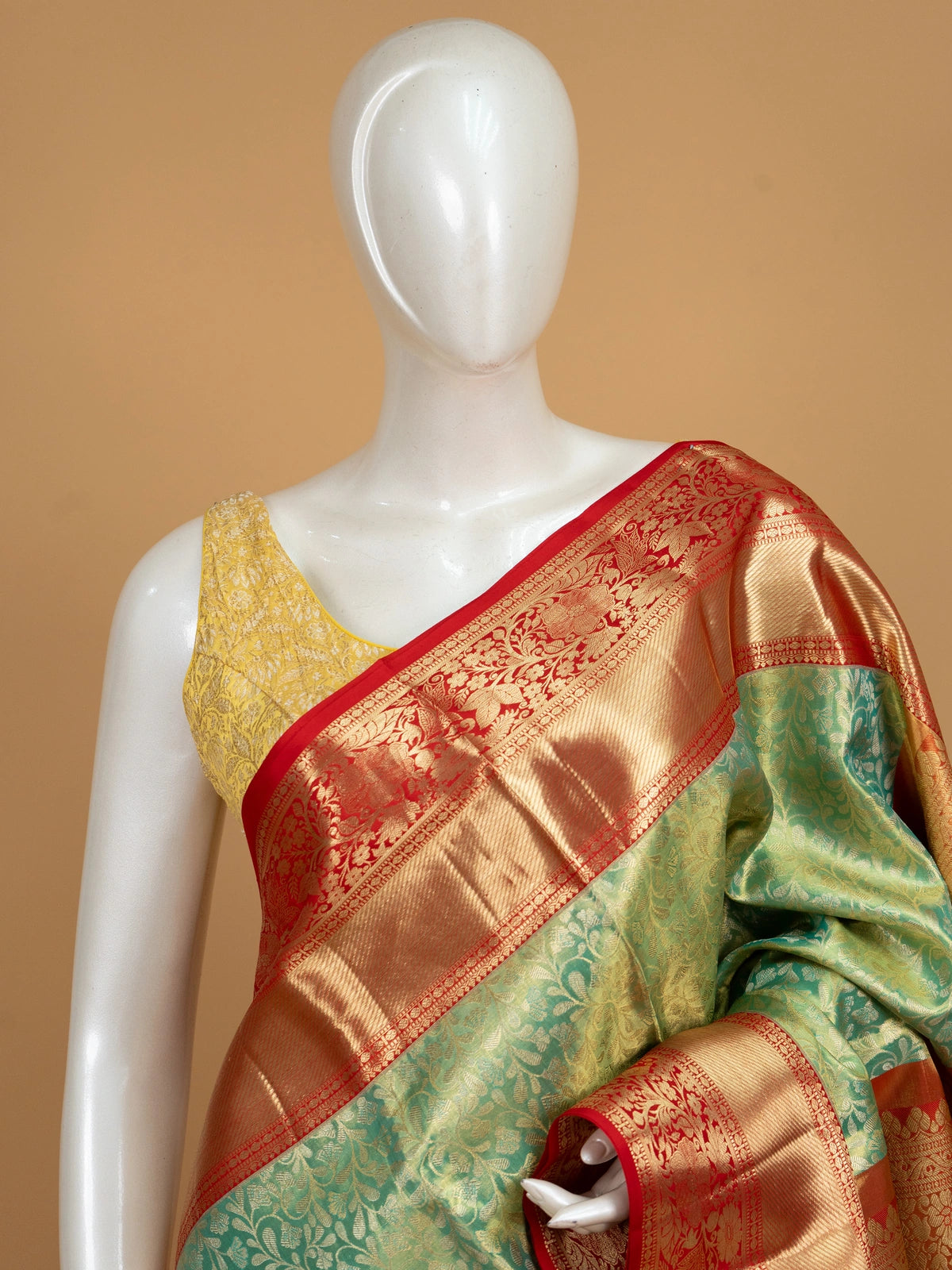 Green pure Kanchipuram silk saree with contrast red border and gold zari floral weaving