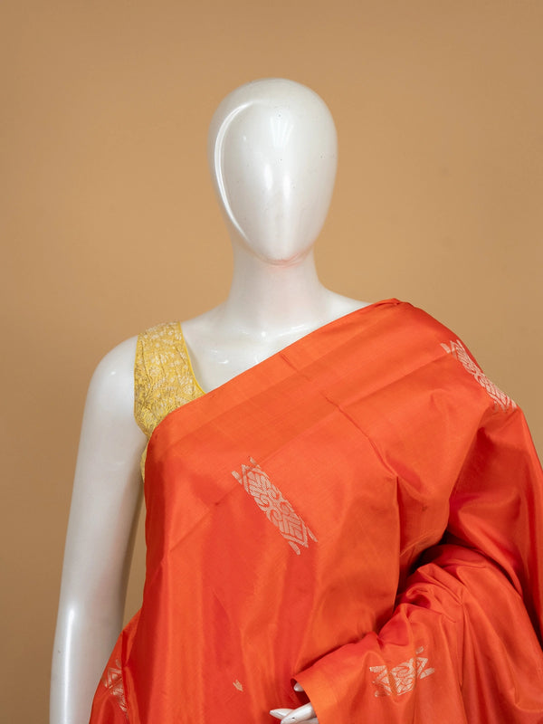Orange banana silk saree with navy blue pallu, silver zari buttas and contrast blouse