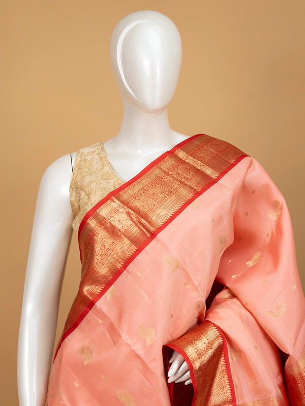 Peach pure Kanchipuram silk saree with contrast red gold zari border and peacock pallu