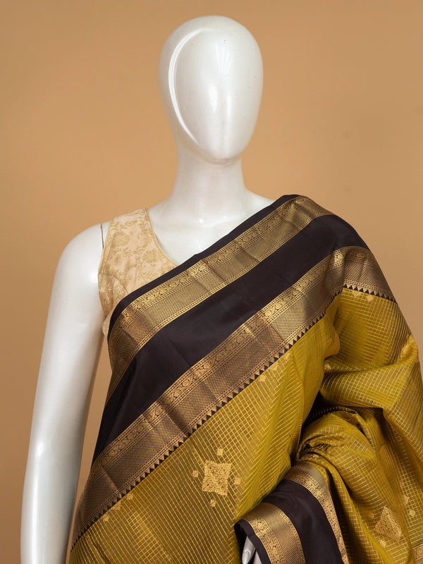 Mehndi green pure Kanchipuram silk saree with dark brown gold zari border and brocade pallu