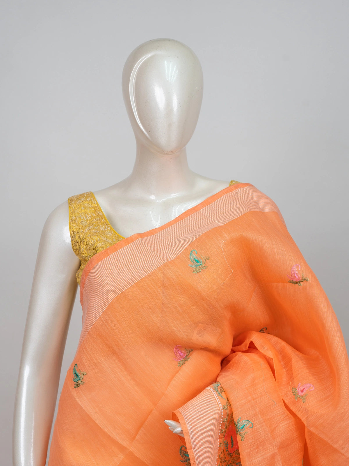 Orange linen cotton saree with silver zari border, paisley embroidery and contrast yellow blouse