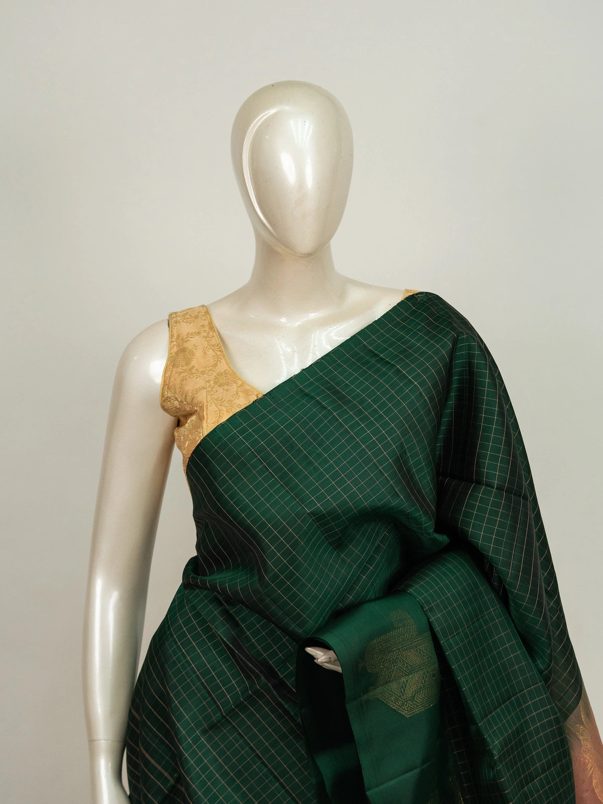 Dark green Kanchipuram pure mix saree with gold zari checks and contrast peach zari border and pallu