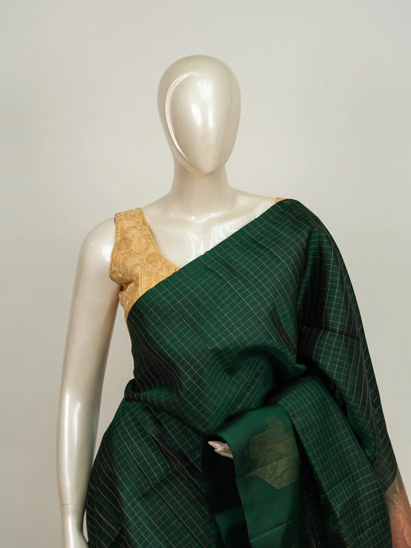 Dark green Kanchipuram pure mix saree with gold zari checks and contrast peach zari border and pallu