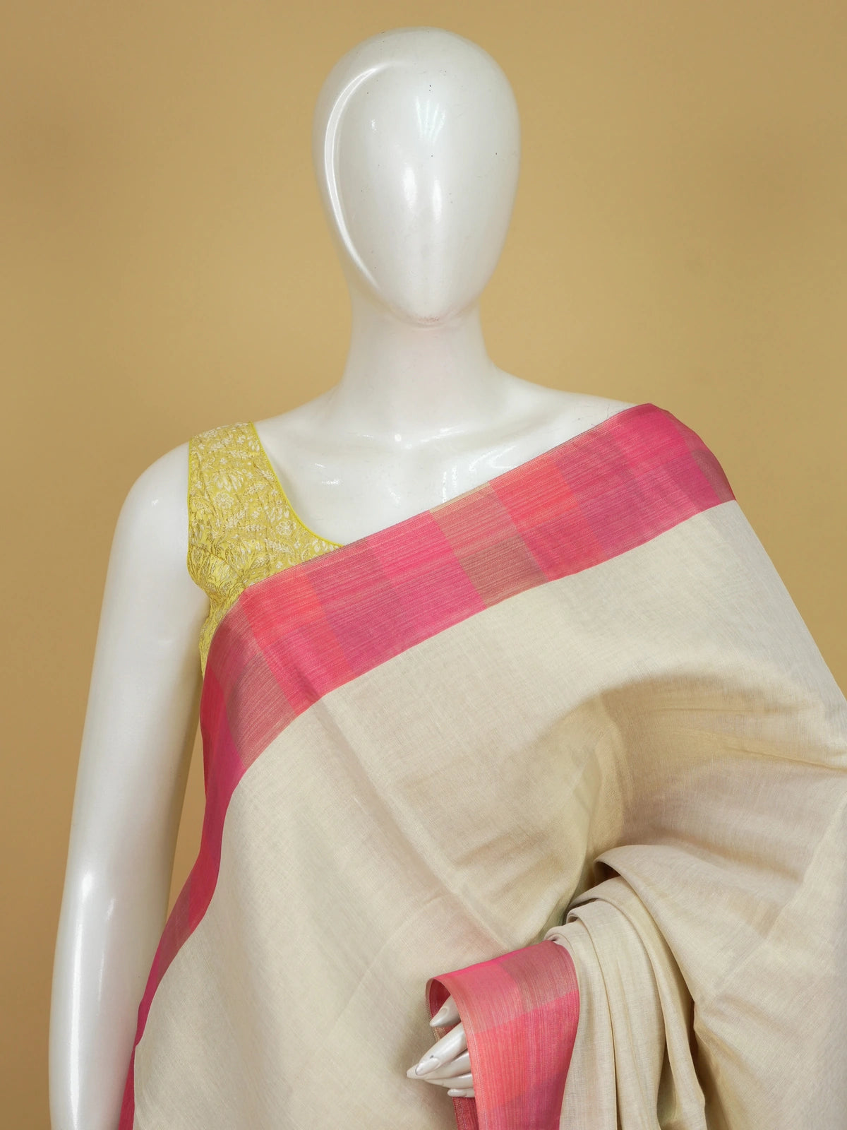 Cream linen cotton saree with pink checked contrast border and pallu