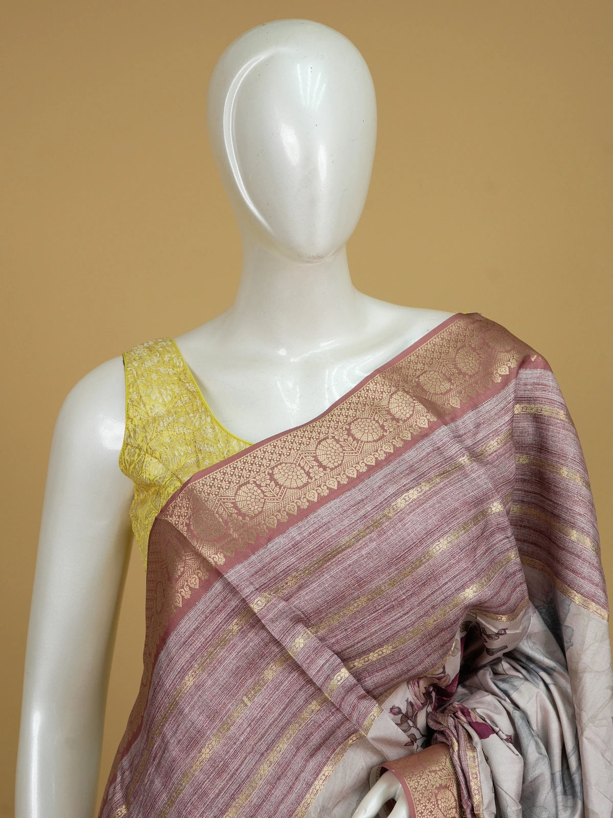 Cream and mauve floral semi tussar saree with gold zari contrast border and printed pallu